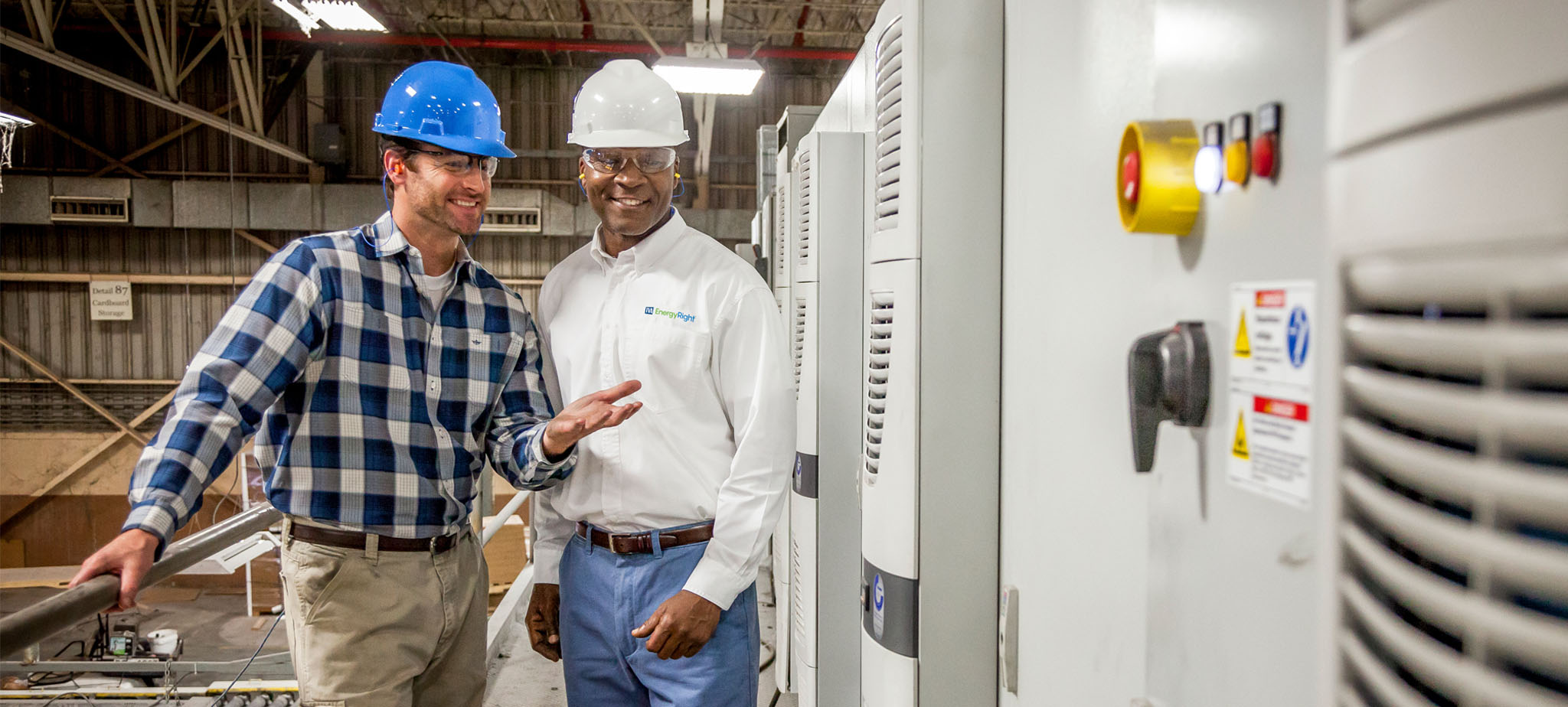 TVA employee talking with worker in a factory