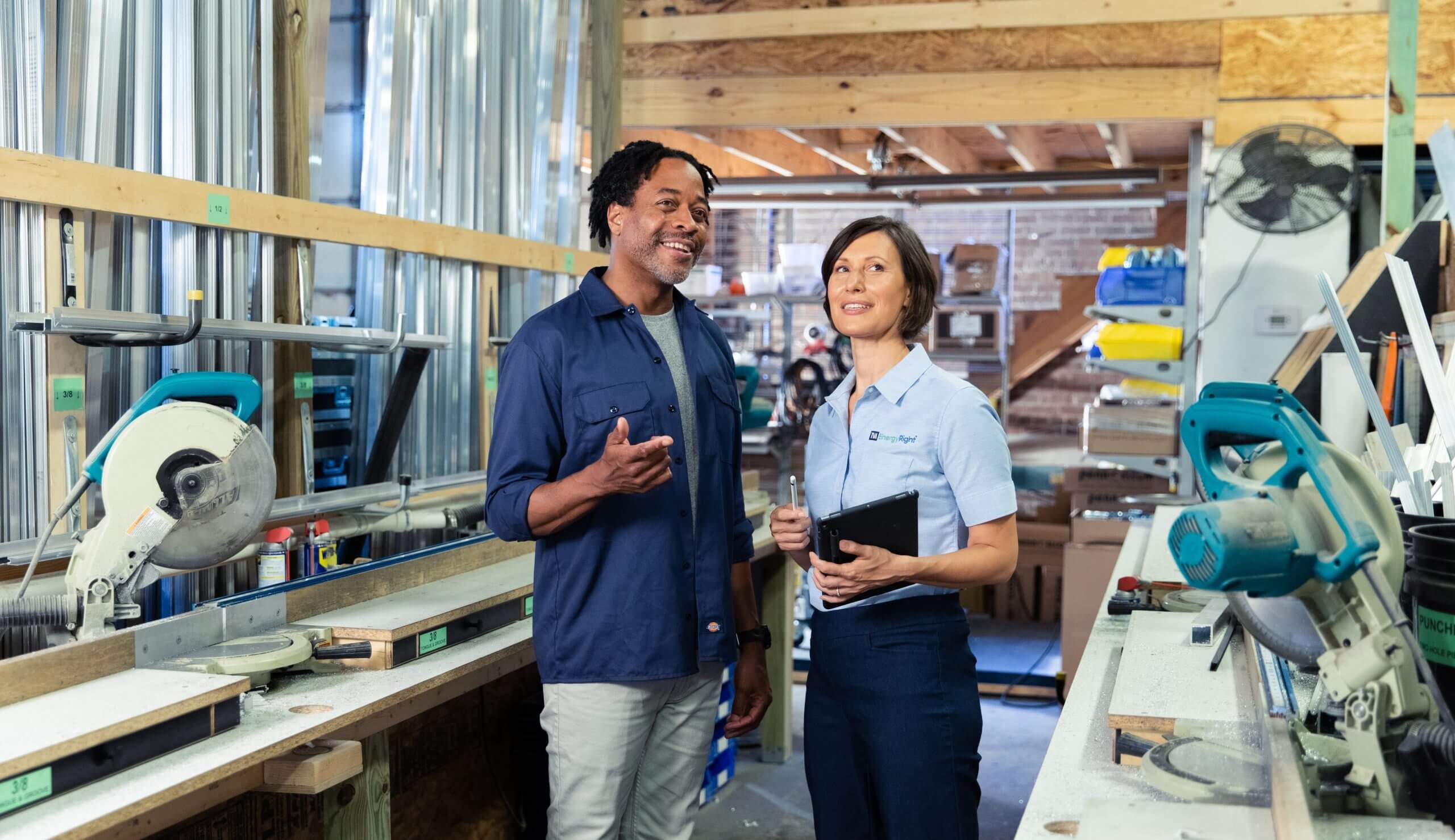 TVA employee with tablet talking to man in industrial facility