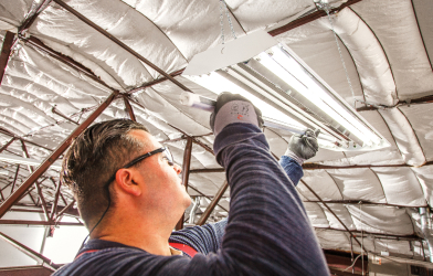 Man replacing fluorescent bulbs