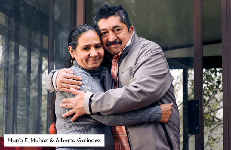 Maria E.. Muñoz and Alberto Galindez hugging on front porch