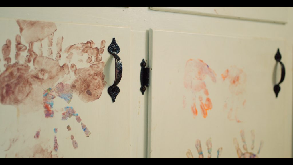 Child handprints on cabinet doors.