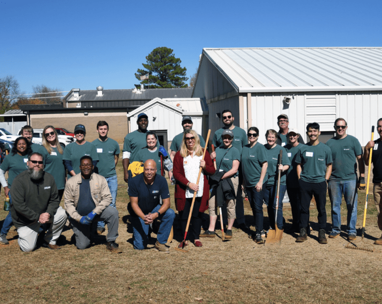 Group of people standing with shovels