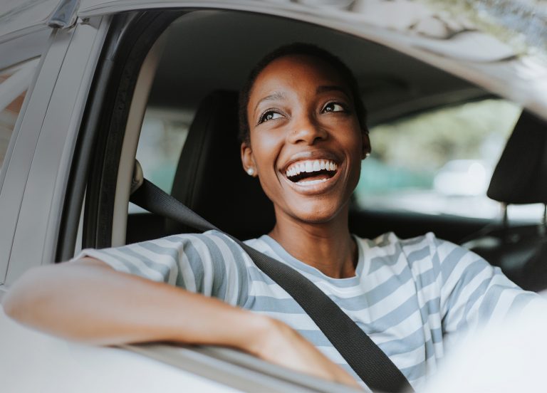 Woman smiling in electric vehicle