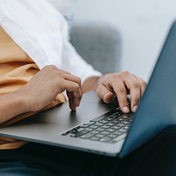 Close up of hands typing on laptop