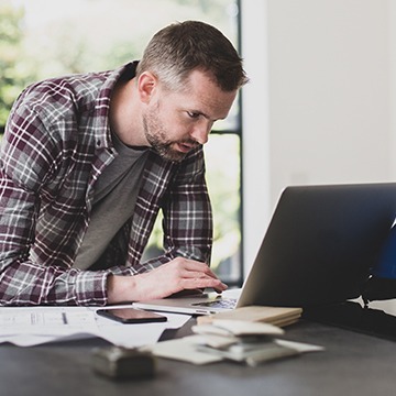 Man looks at laptop computer