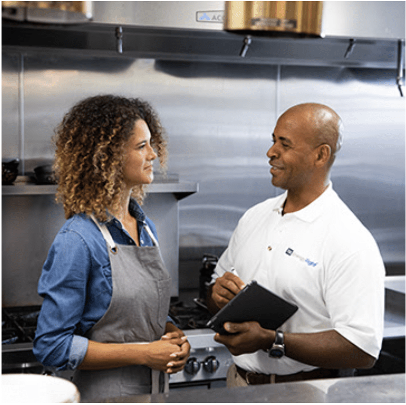 Woman talking to EnergyRight employee in industrial kitchen