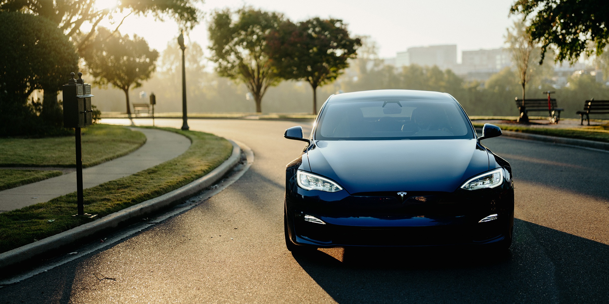 EV driving with sunset in the background