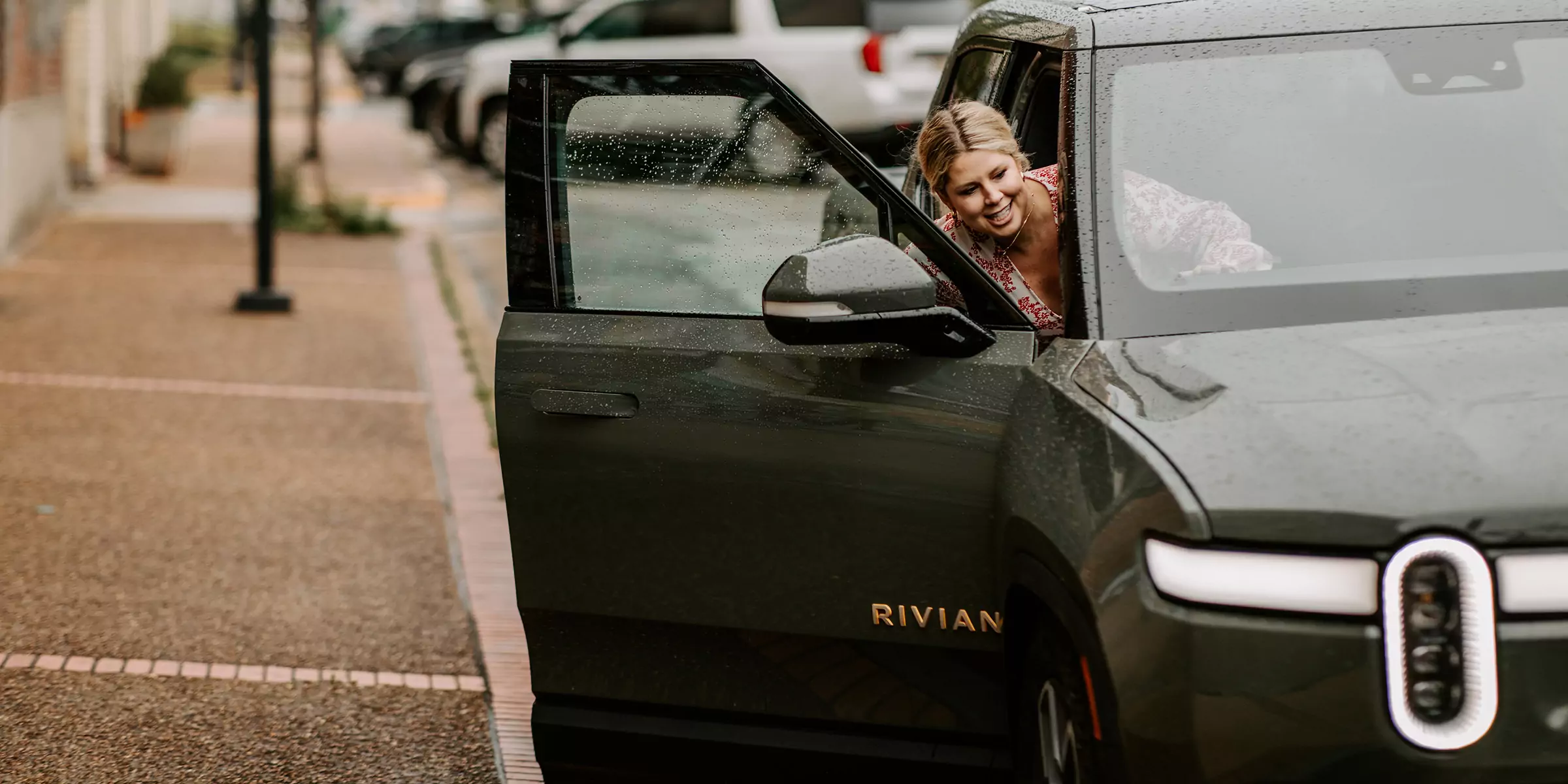 Woman getting into electric vehicle