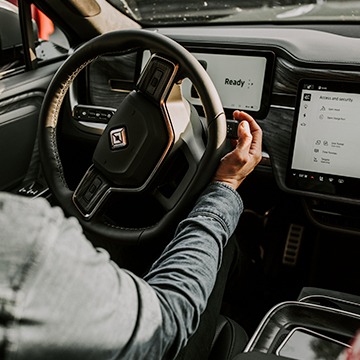 Close up of hand putting an EV truck in drive.