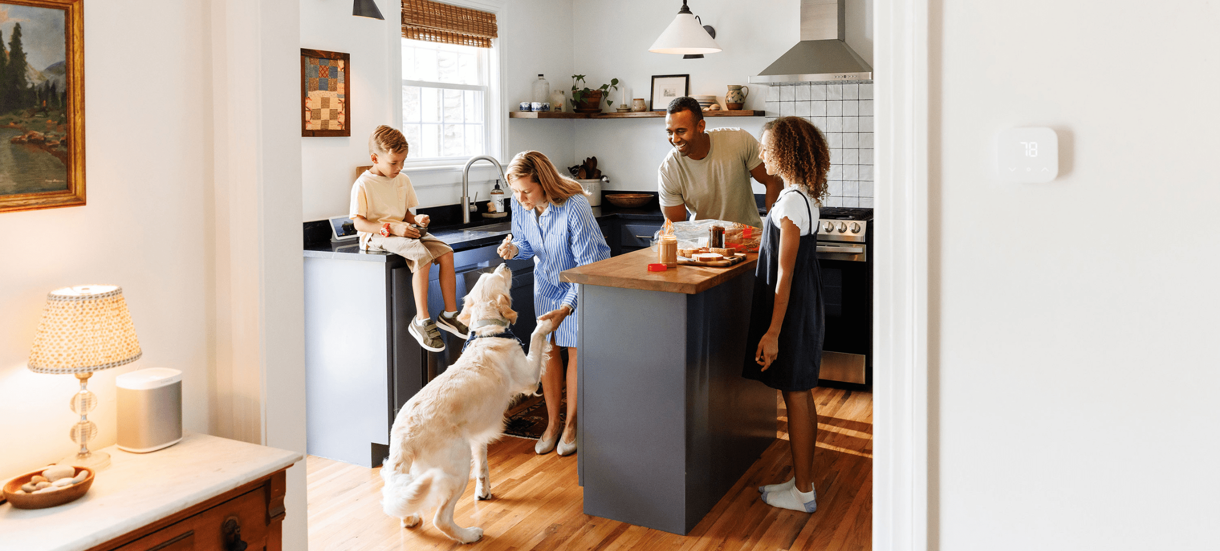 A happy family and sweet golden retriever in a bright and comfortable kitchen, preparing for the day ahead.