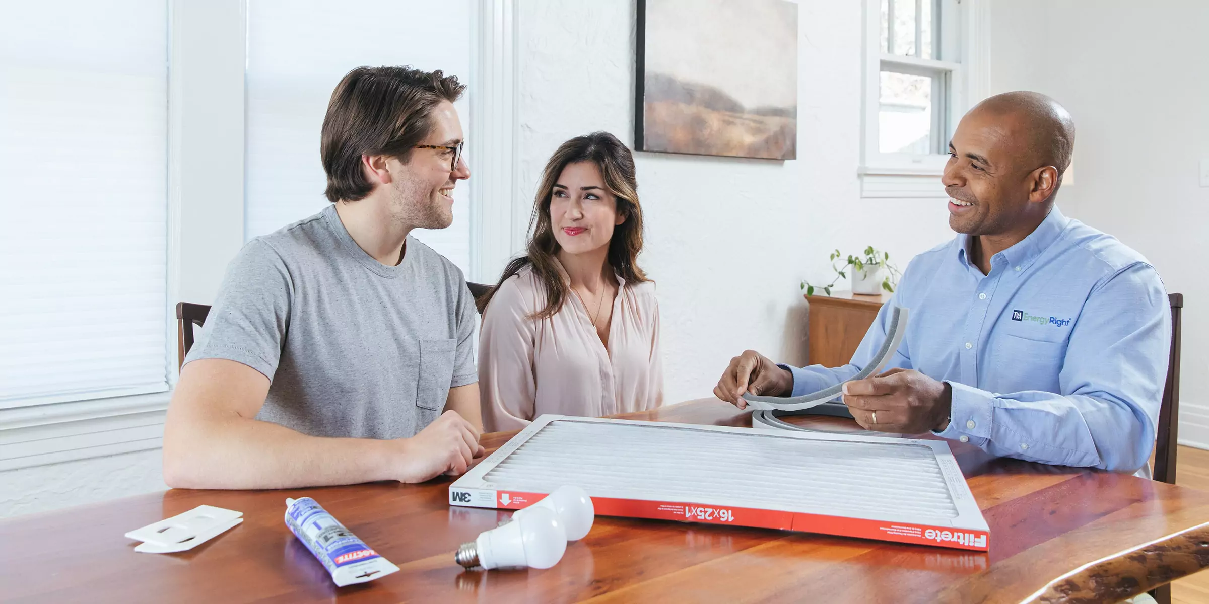 Couple learning about easy home energy efficiency fixes.