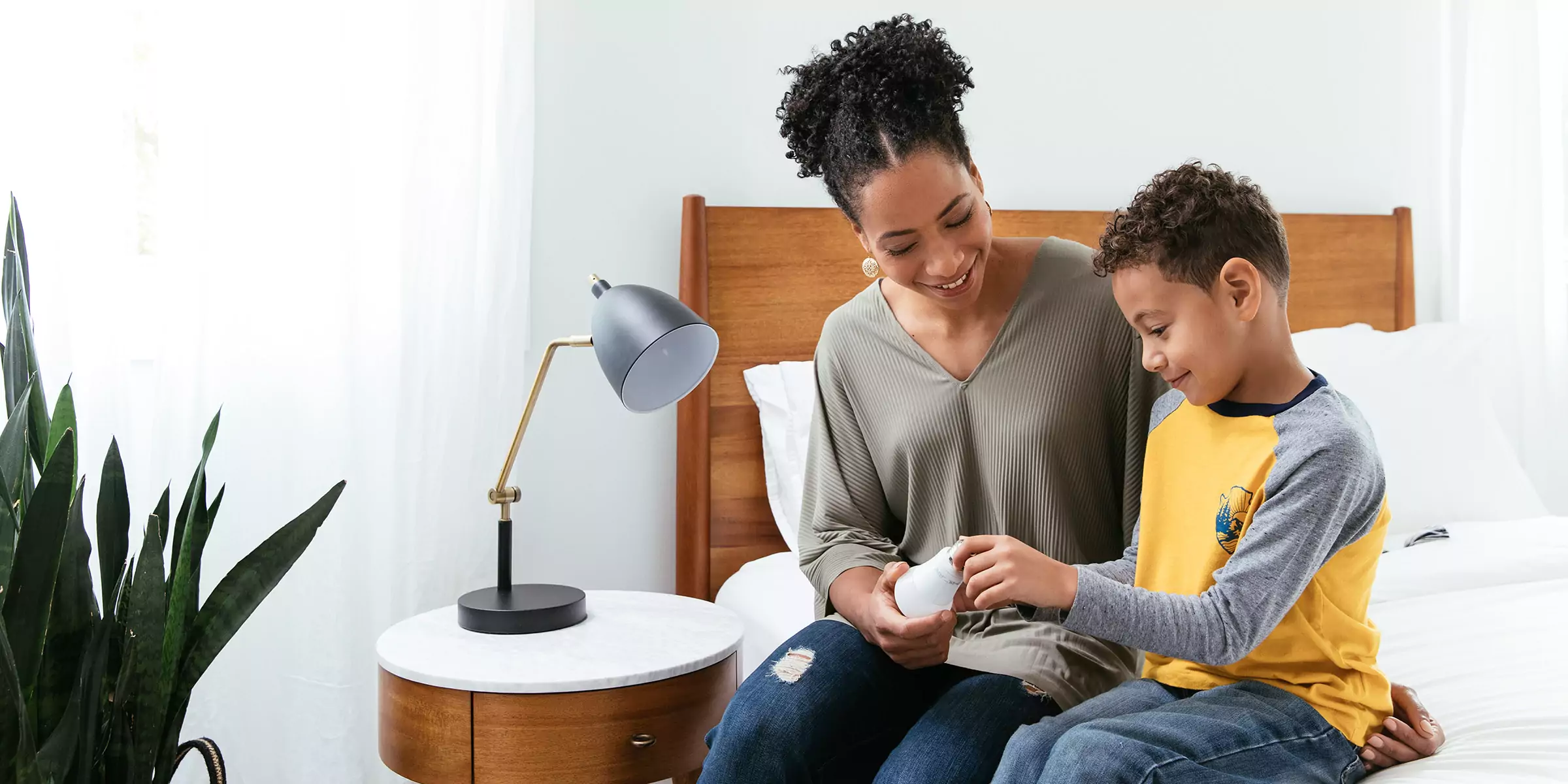 Mother and son changing an LED lightbulb.