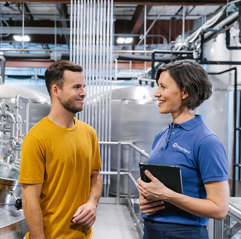 A TVA energy advisor and brewery owner discussing upgrades
