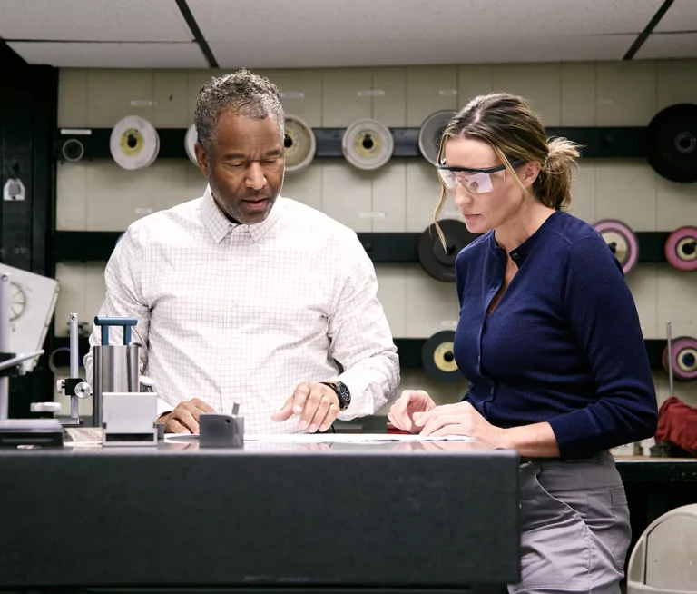 Two colleagues in an industrial workspace.