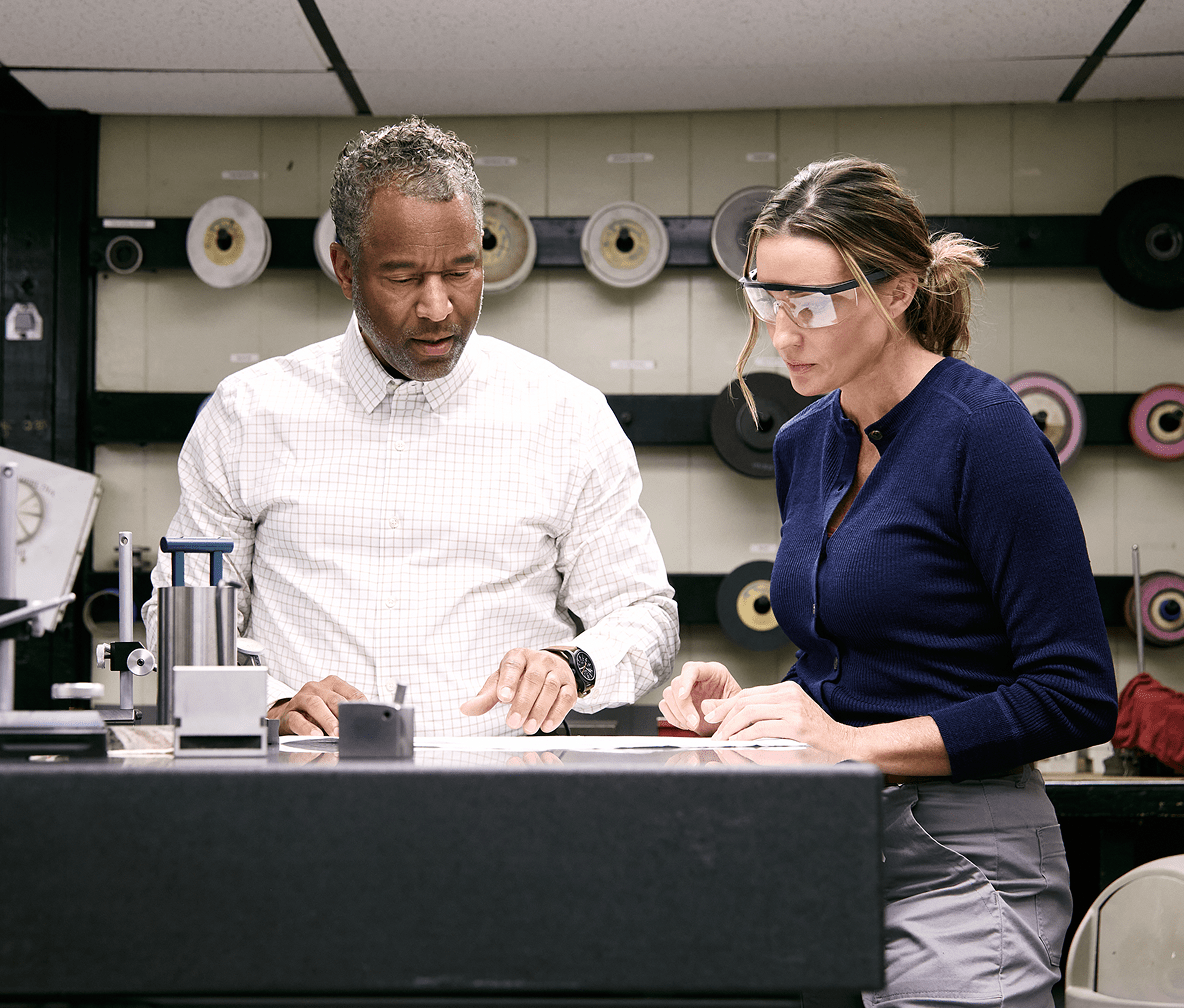 Two colleagues in an industrial workspace.