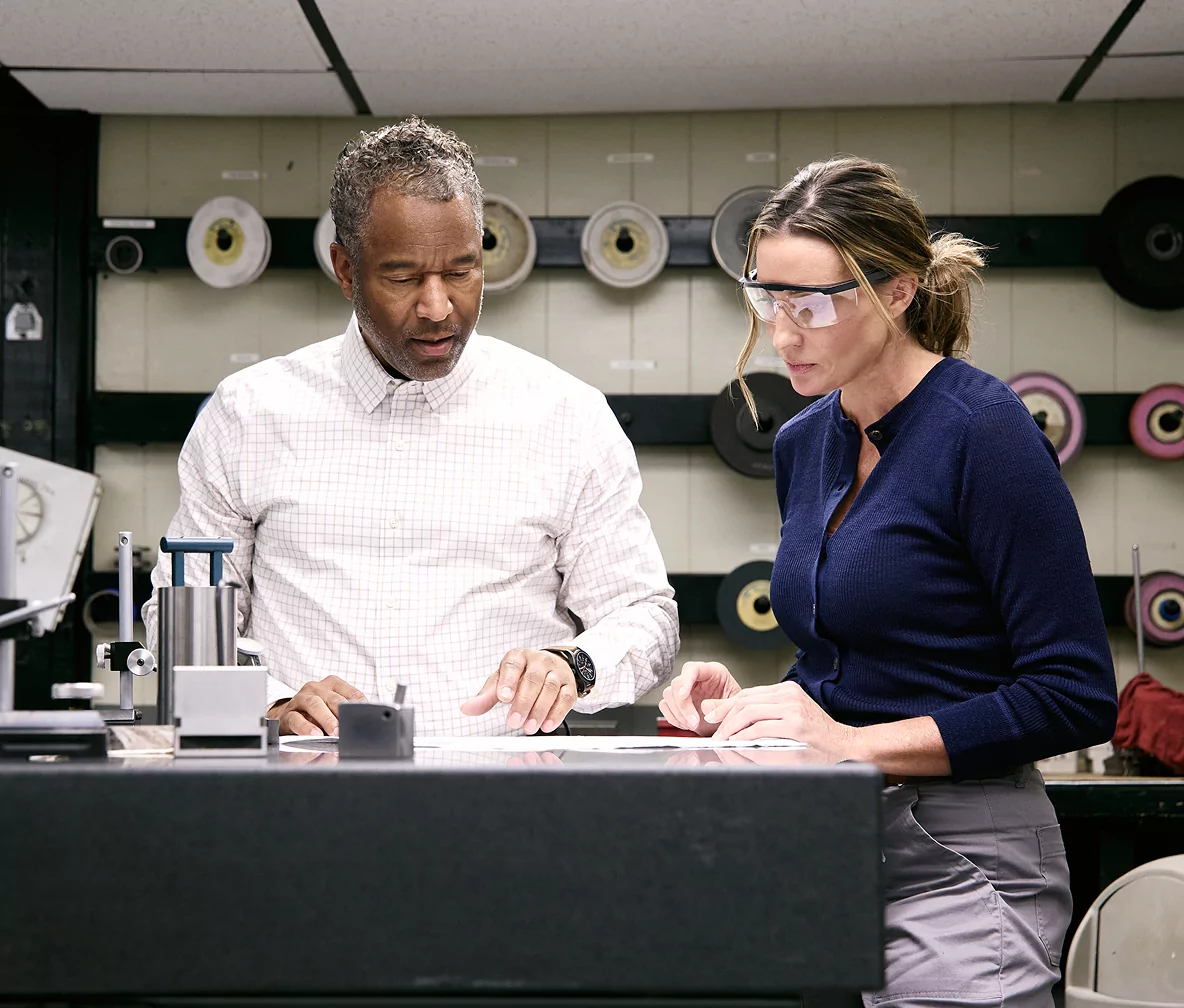 Two colleagues in an industrial workspace.
