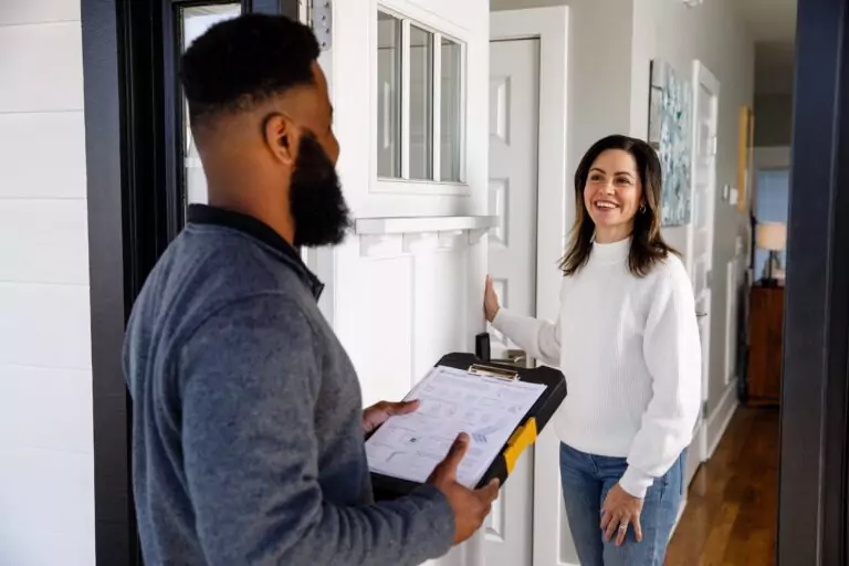 Woman answering the door to a TVA Energy Advisor