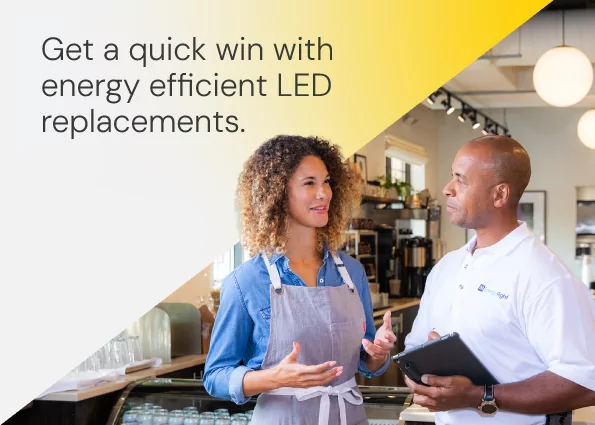 A business owner in an apron discusses facility upgrades with a TVA EnergyRight specialist holding a digital tablet inside a café. Text overlay reads: Get a quick win with energy efficient LED replacements.