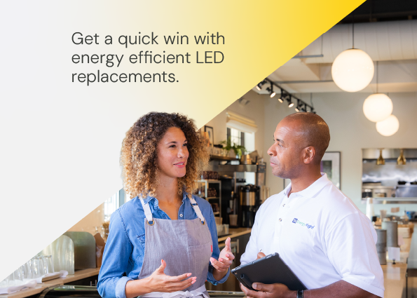 A business owner in an apron discusses facility upgrades with a TVA EnergyRight specialist holding a digital tablet inside a café. Text overlay reads: Get a quick win with energy efficient LED replacements.