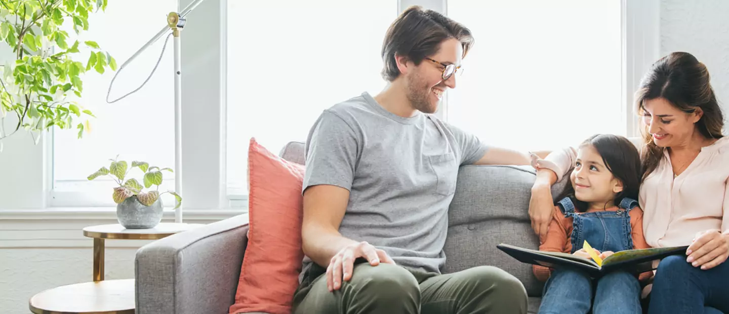 Family enjoying a comfortable, brightly lit home, highlighting the benefits of energy efficiency and home comfort.
