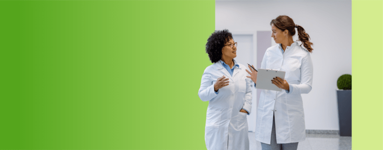Two TVA Energy Experts in white coats collaborate on energy-saving strategies for community initiatives.