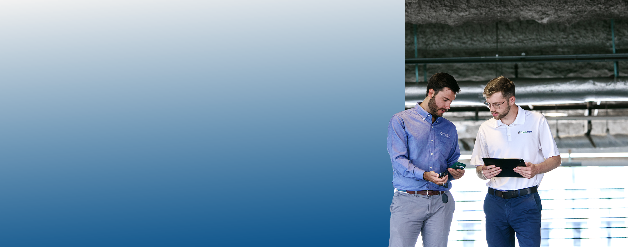 Two TVA Energy Experts use a handheld device and tablet to assess energy solutions in a building.