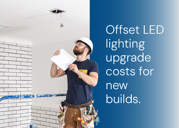 TVA Energy Expert installing an LED light panel, symbolizing energy-efficient LED upgrades and cost offsets for new builds.