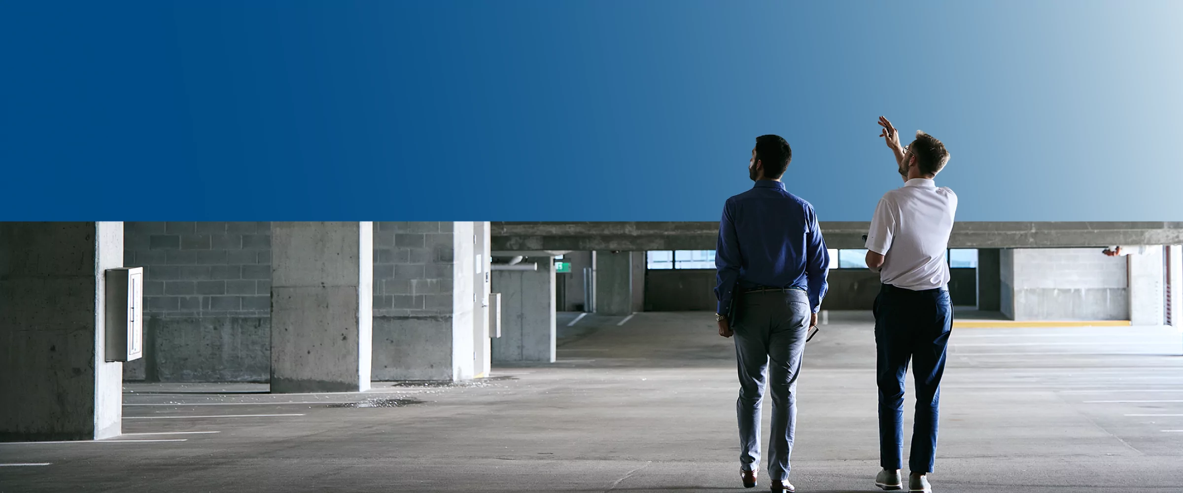 Two TVA Energy Experts assess a commercial building, discussing potential energy-efficient upgrades like LED lighting.