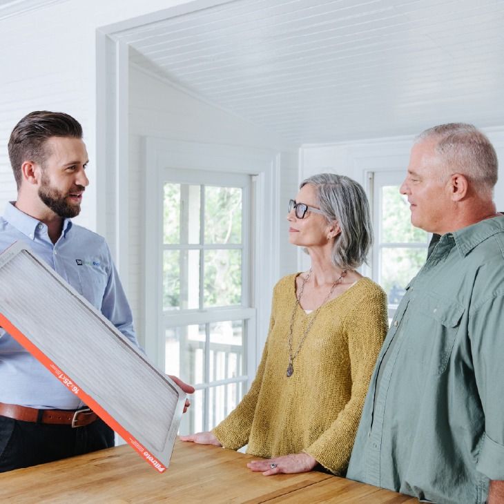 TVA Energy Expert discusses HVAC air filter maintenance with a couple, promoting energy efficiency and healthier homes.