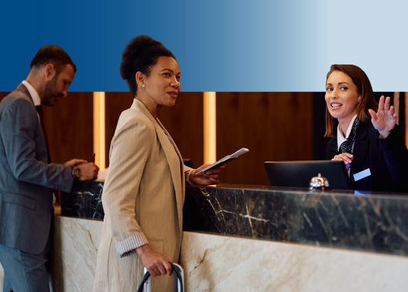 Diverse business travelers interacting with a hotel front desk agent at a modern reception.