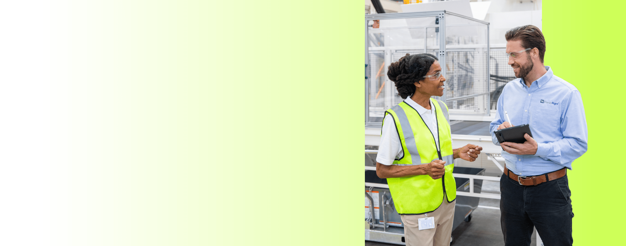 A woman in safety gear consults with a TVA EnergyRight expert holding a tablet in a commercial facility.