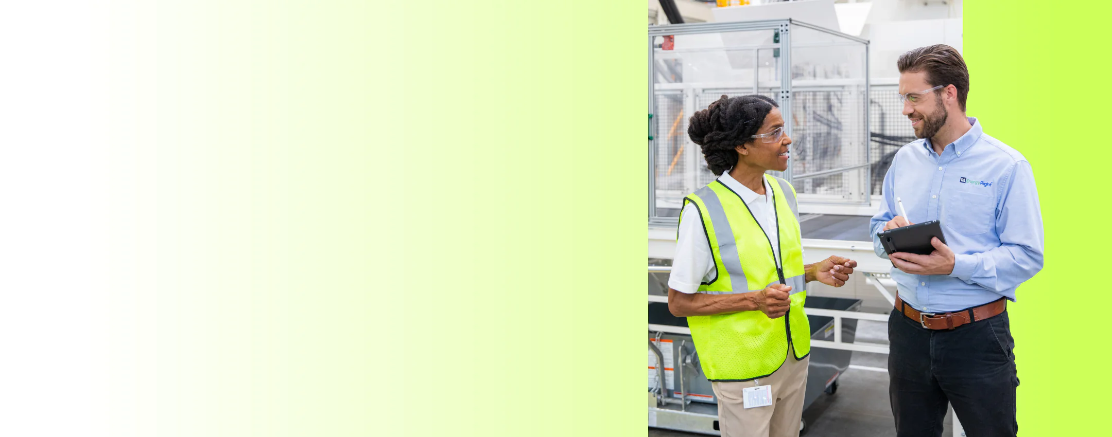 A woman in safety gear consults with a TVA EnergyRight expert holding a tablet in a commercial facility.