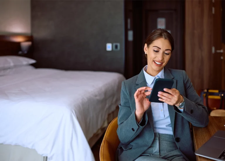 TVA Energy Expert smiling, managing energy use or smart home devices remotely on her smartphone.